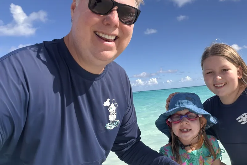 Family selfie in clear turquoise water at the beach