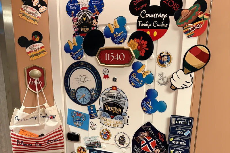 Our stateroom door with the cabin number plaque surrounded by magnets
