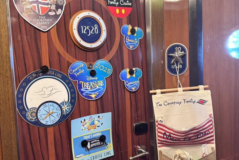 Personalized name magnets and pouches on our stateroom door