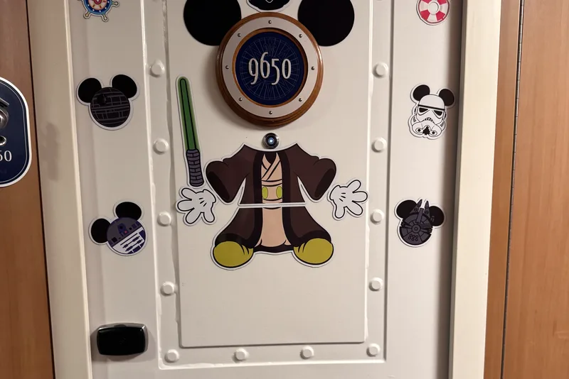 Porthole frame magnet around a cabin number plaque