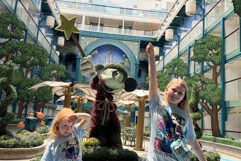Kids posing by the sorcerer topiary in the ship atrium