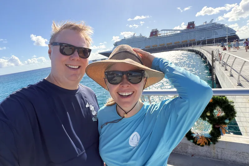 Couple selfie on the pier with the cruise ship behind