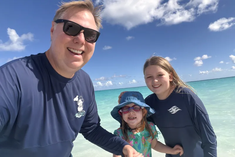 Family selfie in clear turquoise water at the beach